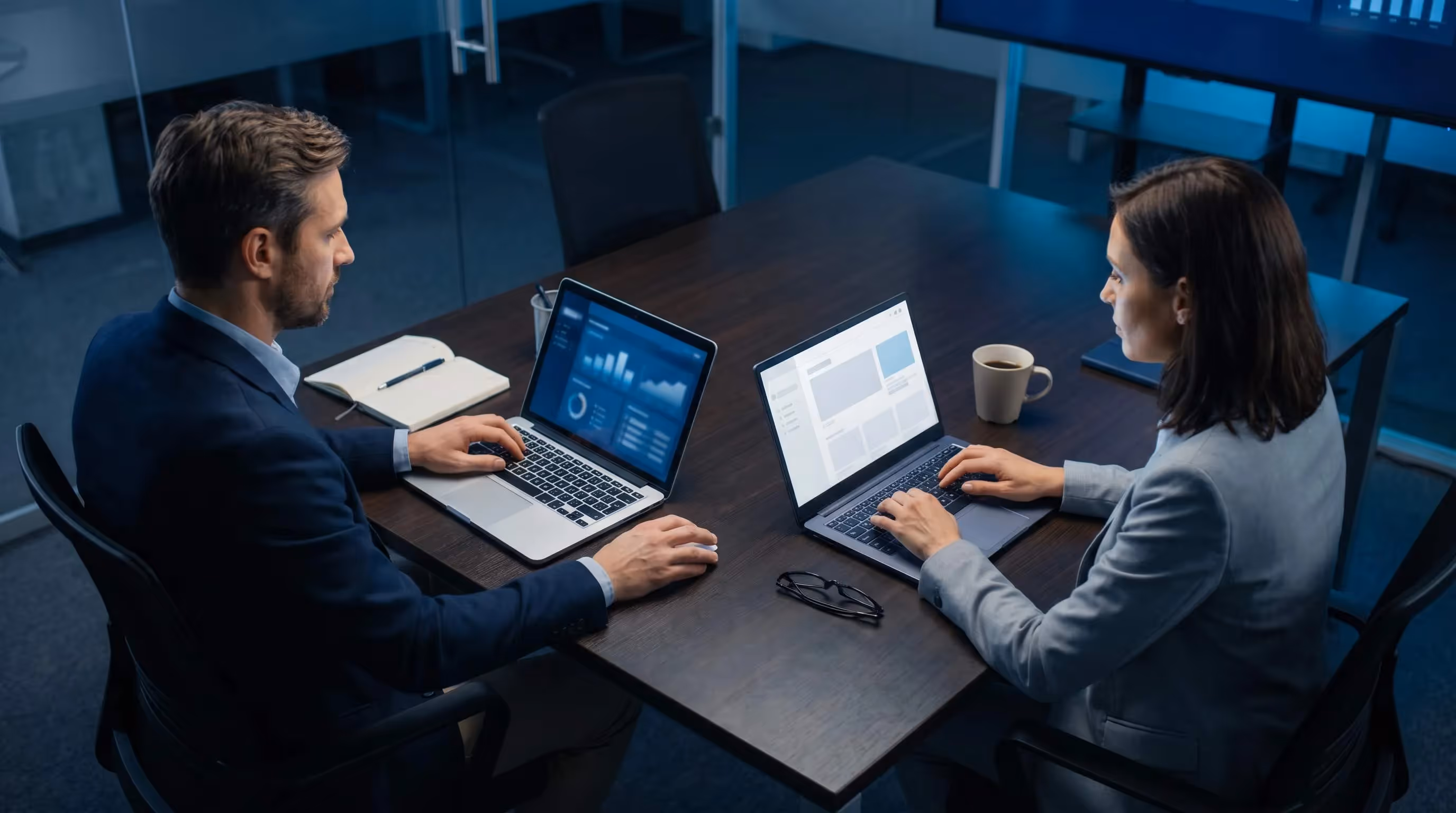 Overhead shot of two laptops showing branded client SEO dashboard and white-label deliverable side by side