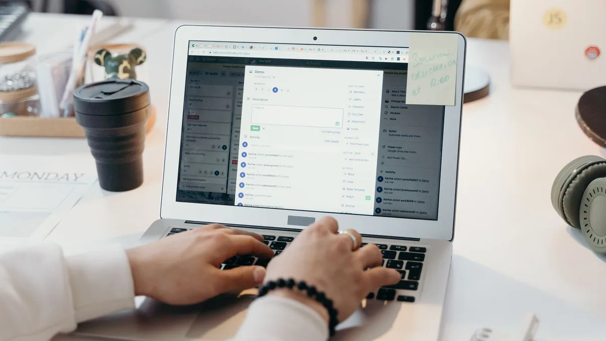 Person typing on a laptop in a bright office, illustrating the ranking of the best email marketing agencies in France