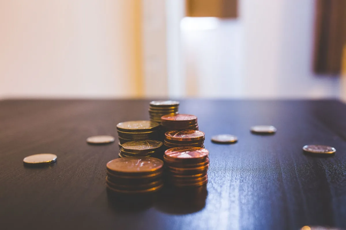 Small stacks of coins on a dark table