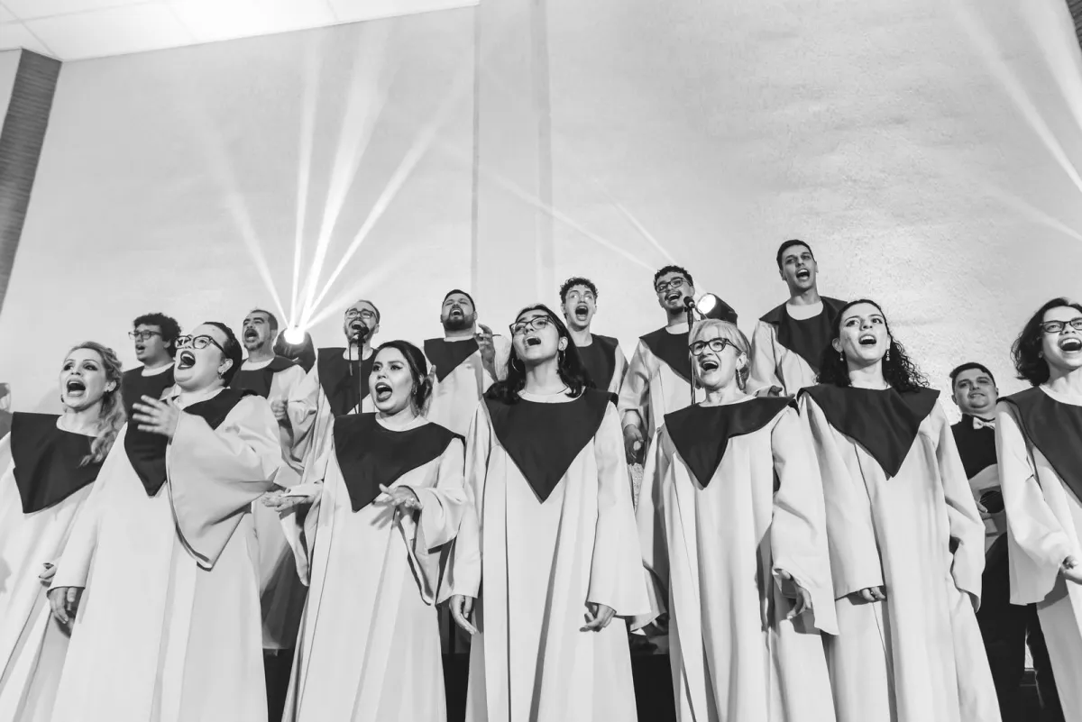 Choir singing together on stage in black and white