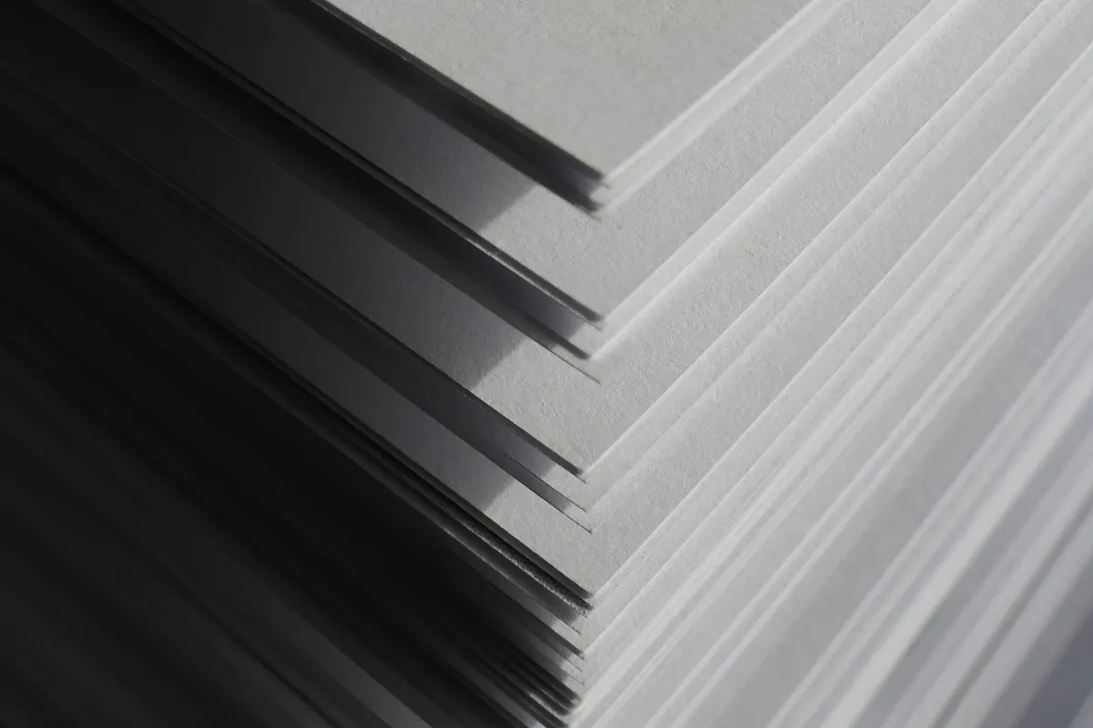 Close-up of the edges of stacked white paper sheets forming layers