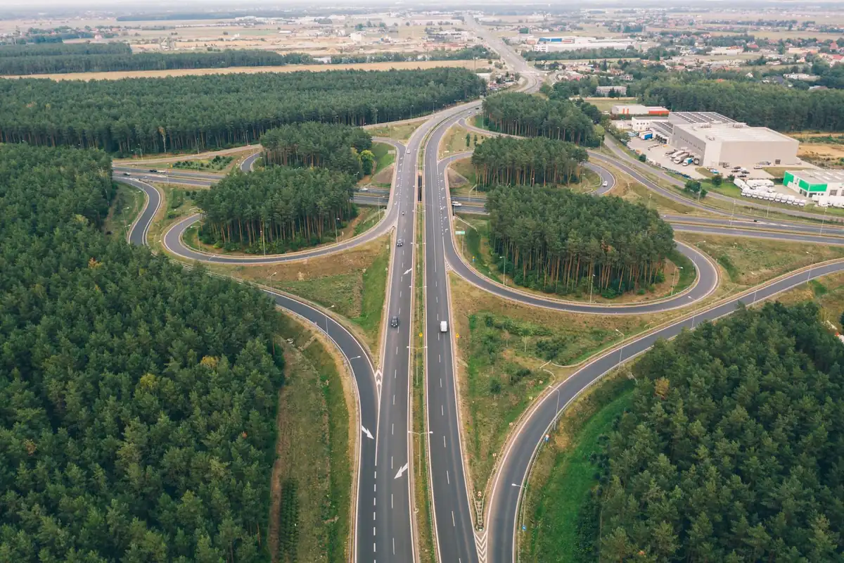 Aerial view of a highway interchange surrounded by forest