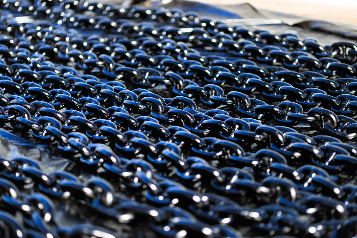 Shiny metal chains laid out in rows outdoors