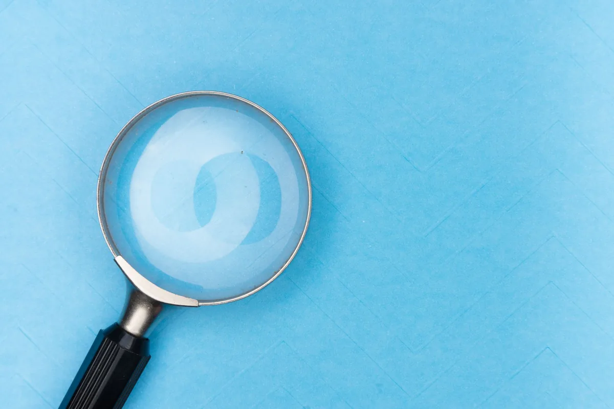 Magnifying glass lying on a light blue surface