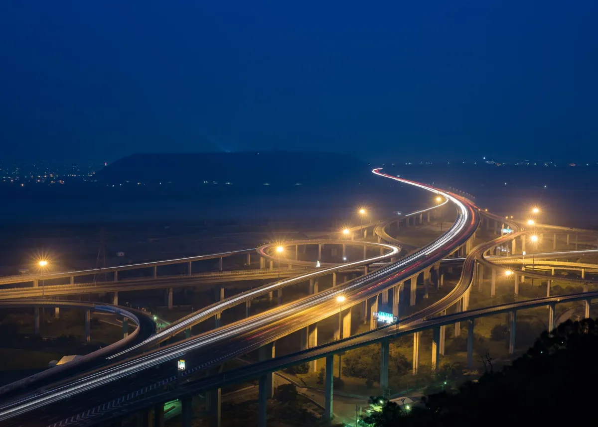 Elevated road junction with glowing street lamps at dusk