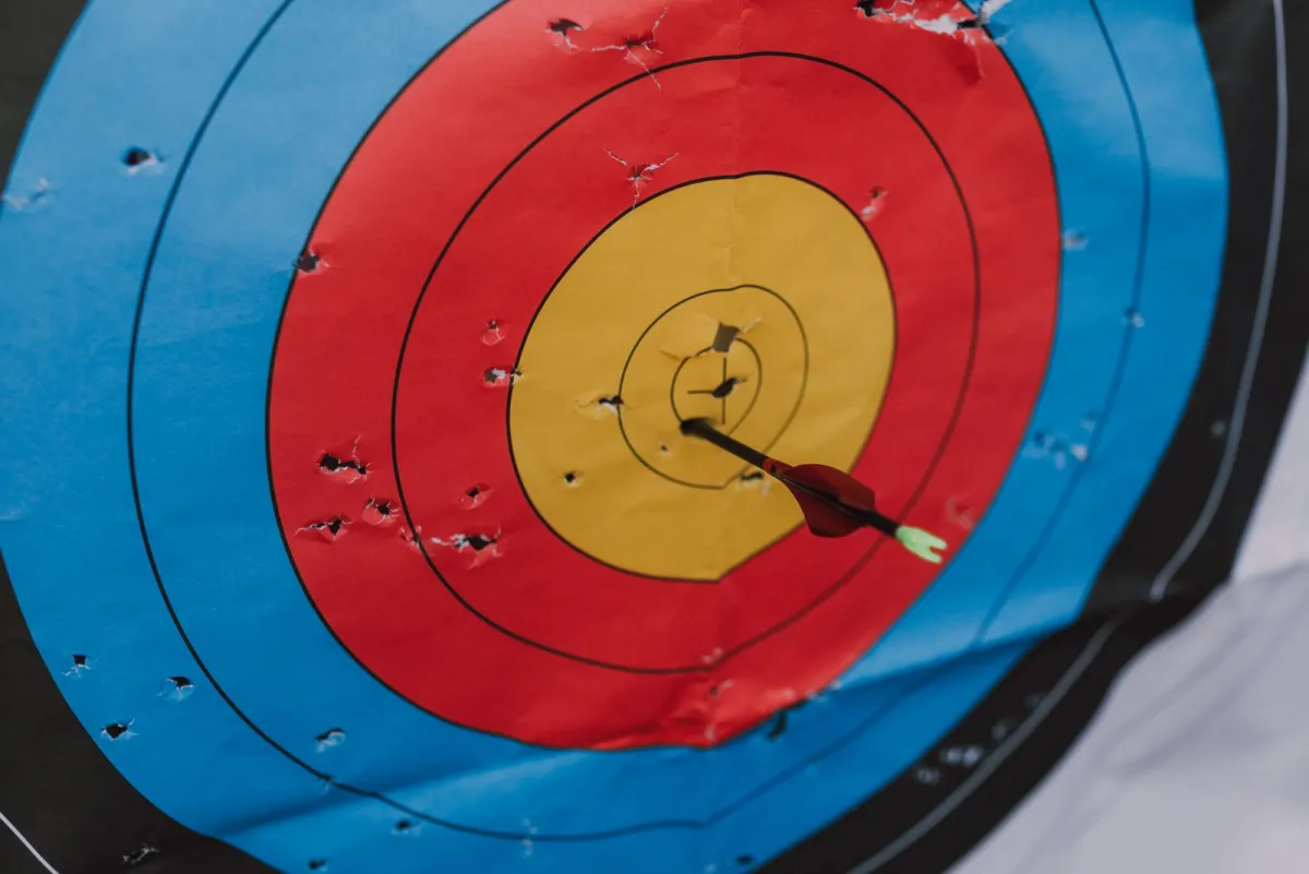 Archery target with an arrow stuck near the center